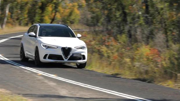 2021 Alfa Romeo Stelvio Quadrifoglio SUV white exterior front 3/4 driving shot 2