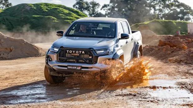 2023 Toyota Hilux GR Sport driving through mud
