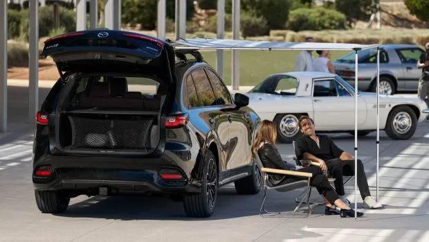 2024 Mazda CX-70 with side awning and people sitting down